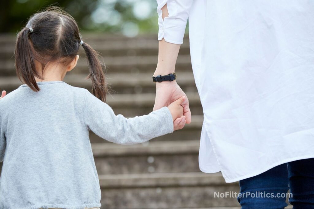 Child Holding Adult's Hand on Stairs