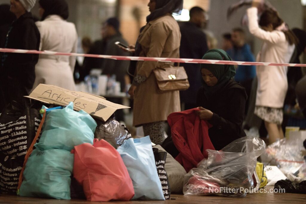 Aid Worker Distributing Clothes at Charity Collecting Point
