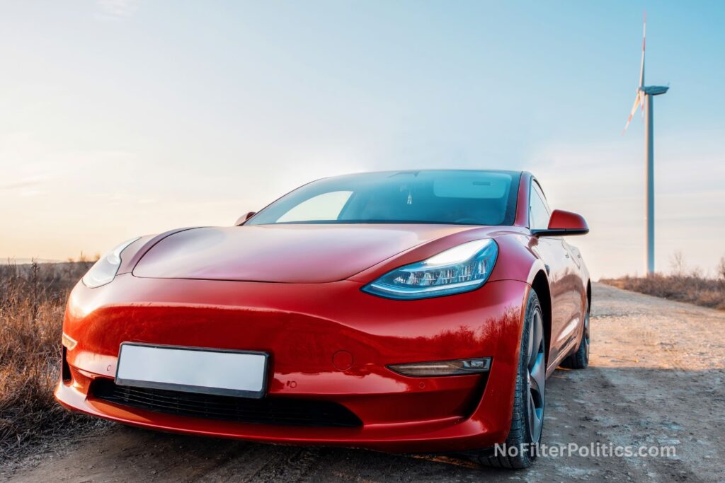 Parked red Tesla Model 3 at sunset